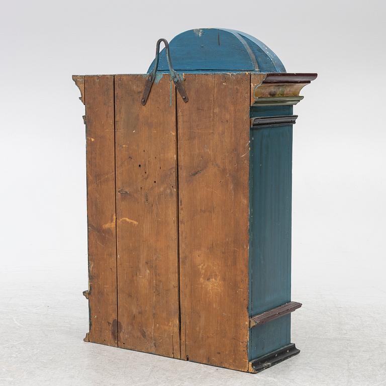 A 19th century folk art hanging cabinet.