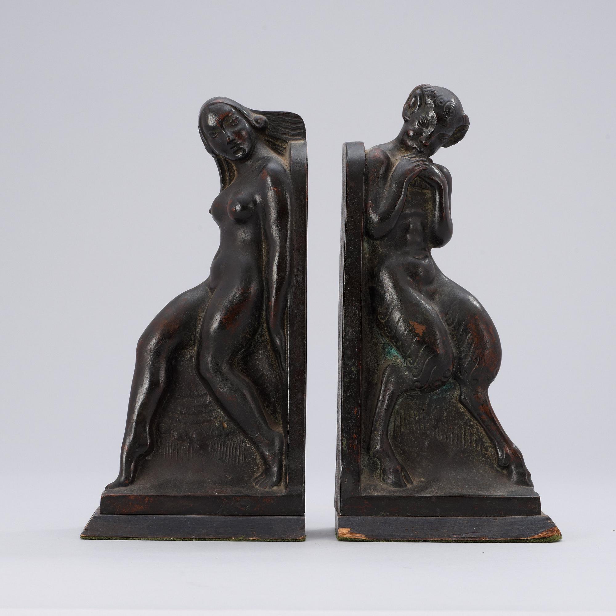 A pair of Axel Gute patinated bronze bookends, Sweden 1919.
