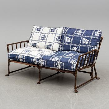 A contemporary bamboo imitating garden sofa.