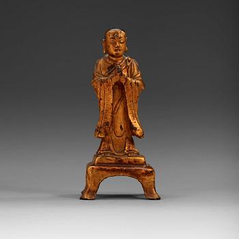 A lacquered gilt figure of a standing monk, Ming dynasty (1368-1644).