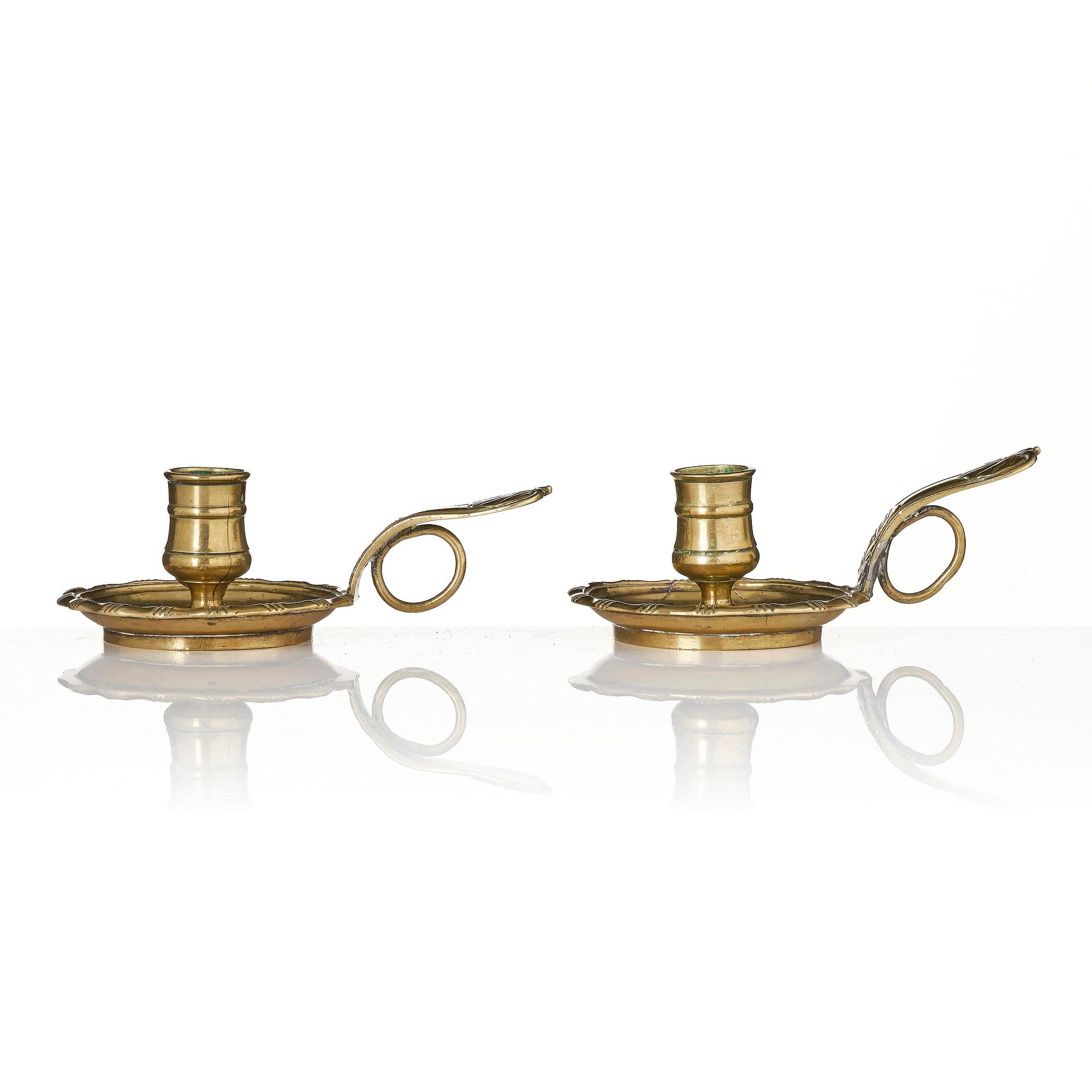 A pair of rococo brass candlesticks possibly by C. Liendenberg (active in Stockholm from 1745).