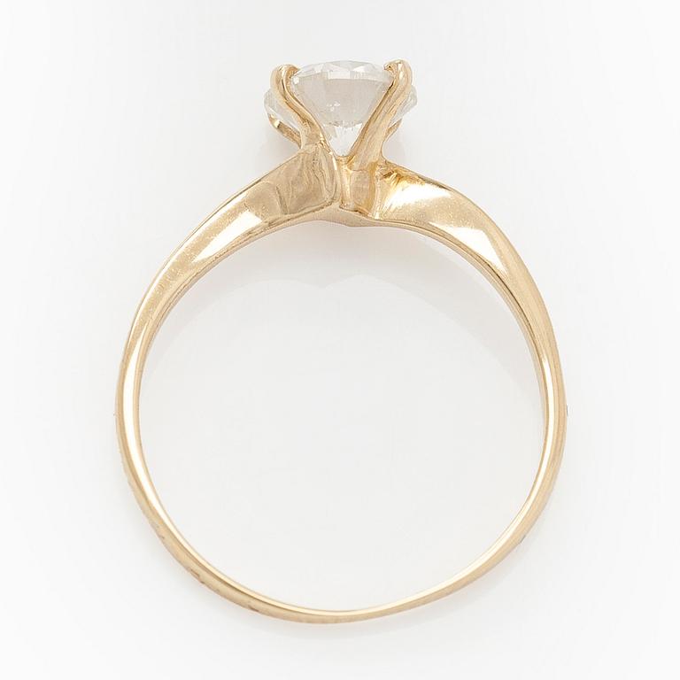 A 14K gold ring with brilliant cut diamond.
