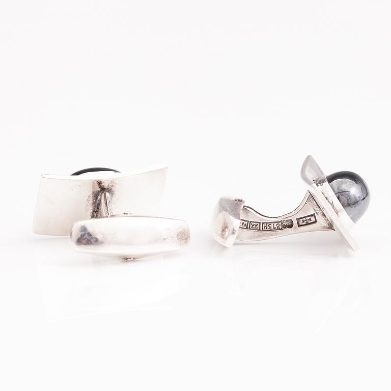 A set of three pairs of silver cufflinks with hematite, tigers eye and granite. Turun Hopea and Osvald Mättö.