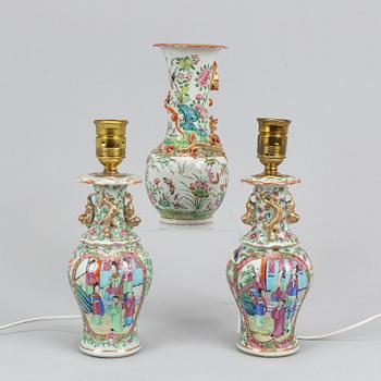 A pair of famille rose Canton table lamps and a vase, Qing dynasty, 19th Century.