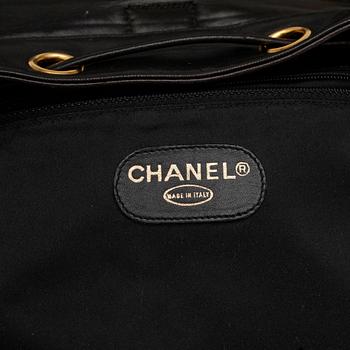 CHANEL, a black leather quilted backpack.