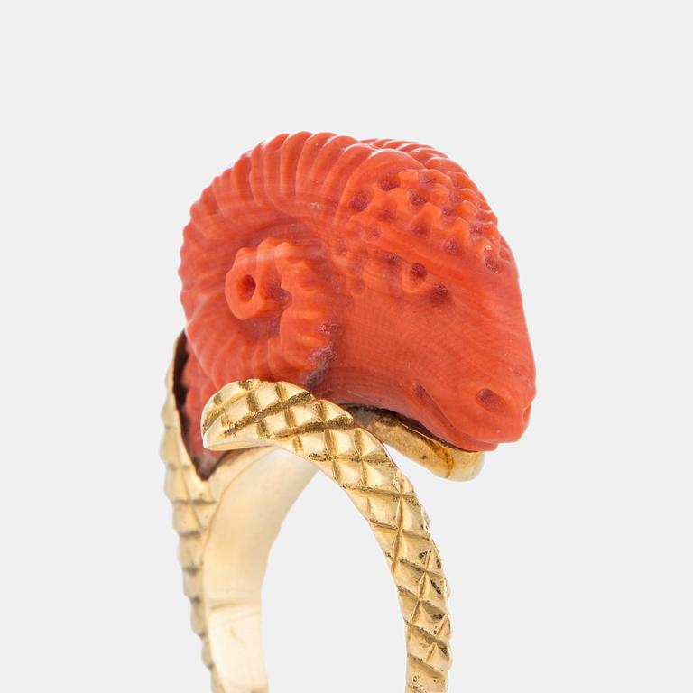 A ring in carved coral in the form of a ram's head.