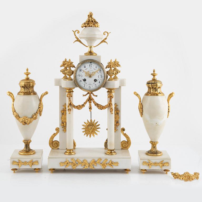 A set with a mantle clock and two urns, France, circa 1900.