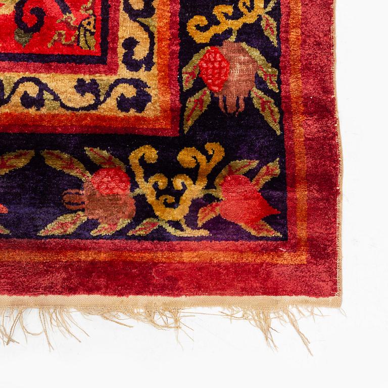 An East Turkestan silk carpet, ca 308 x 182 cm.