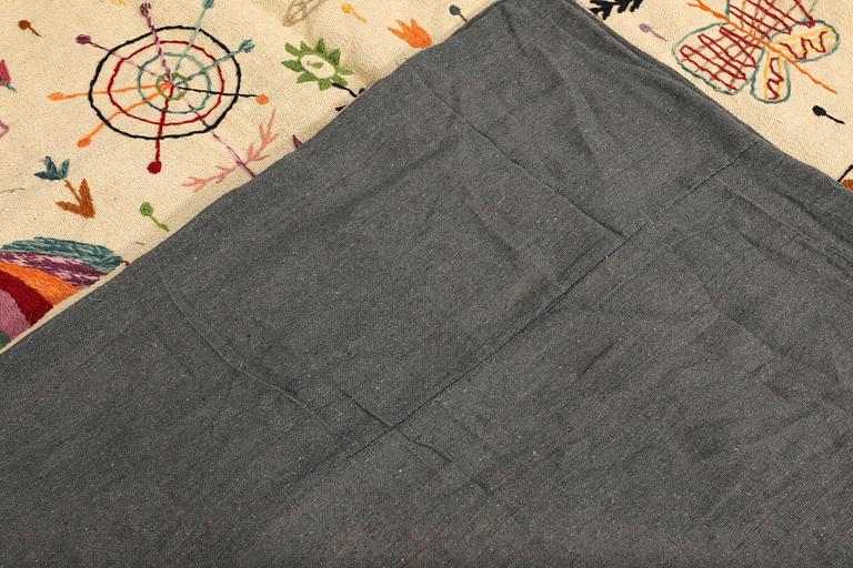 A hand-embroidered Kilim rug, approx. 240 x 181 cm.