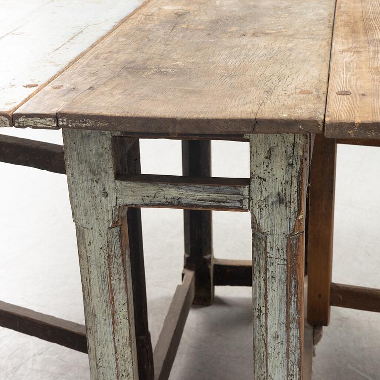 A 18th century gate-legged pine table.