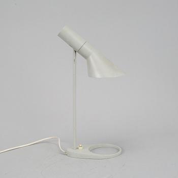 Arne Jacobsen, a grey lacquered 'AJ' table lamp for Louis Poulsen /by license Axel Annell.
