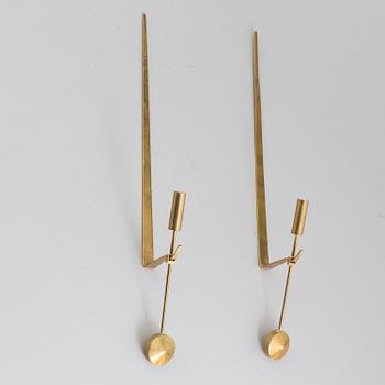 A pair of brass 'Pendeln' candleholders by Pierre Forsell, Skultuna.