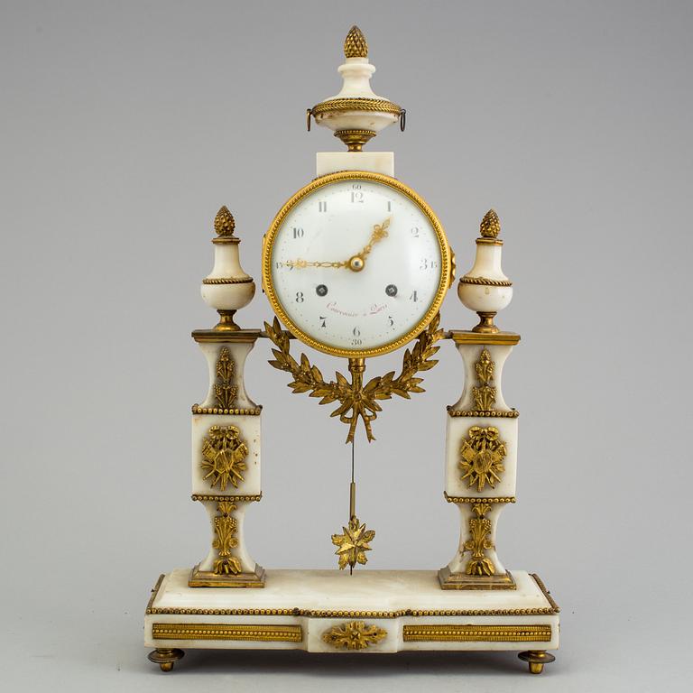 A Louis XVI marble and bronze mantel clock from the second half of the 18th century.