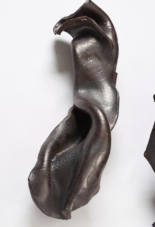 Hertha Hillfon, a black glazed stoneware wall sculpture in two parts of a face and a sky, executed in her own studio, Stockholm 1960s.