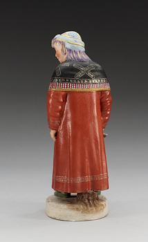 A Russian bisquit figure depicting a Khanty woman, Gardner ca 1924.