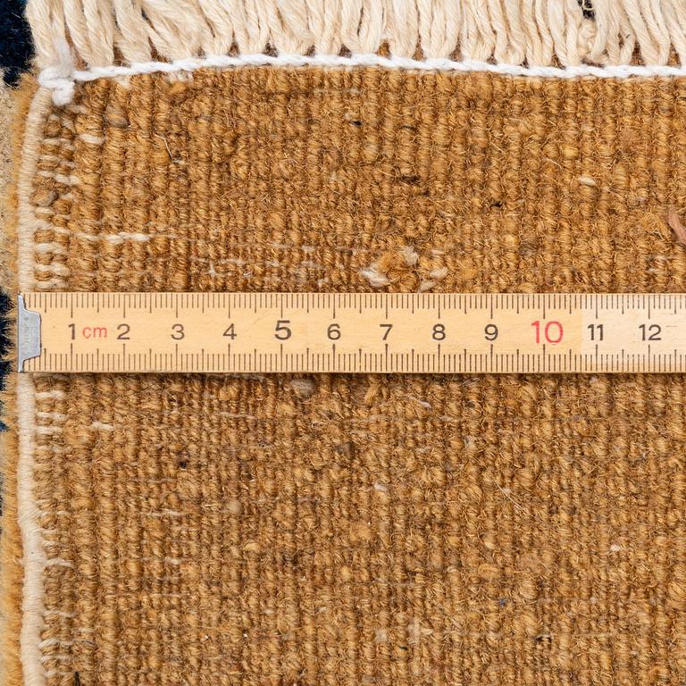 An antique Chinese carpet, 404 x 304 cm.