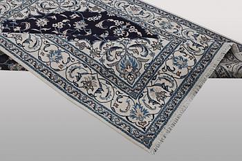 A carpet, Nain, part silk, ca 256 x 199 cm.