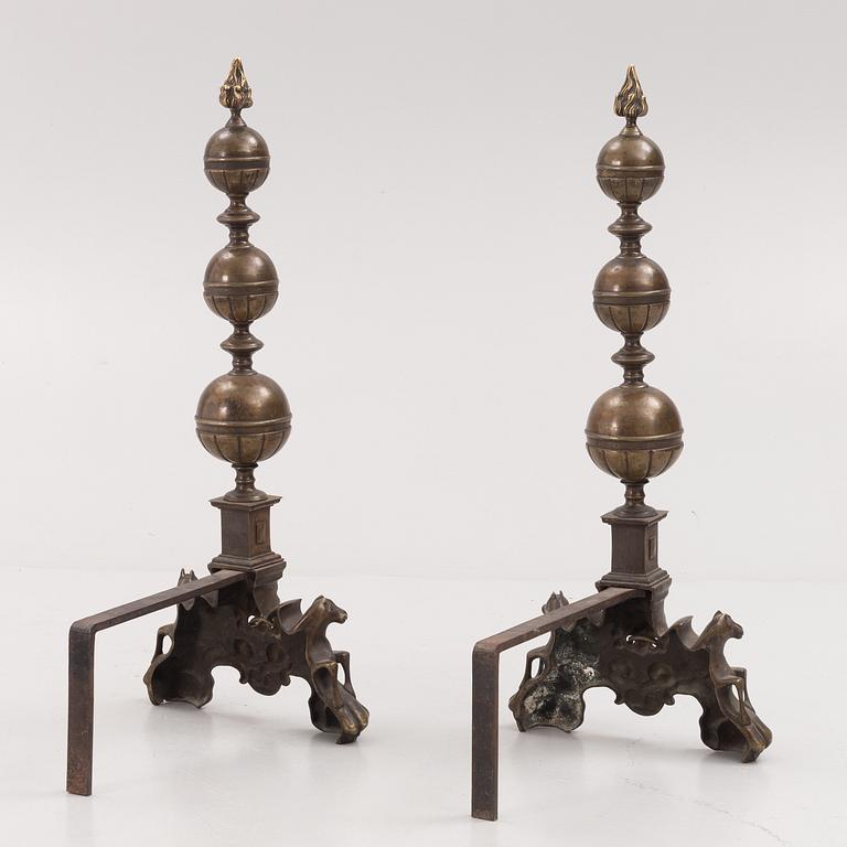 A pair of brass andirons, first half of the 20th century.