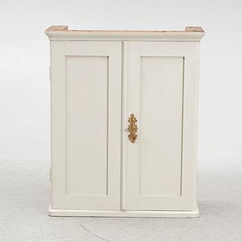 A wall cabinet, circa 1900.