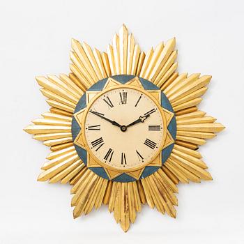 A mid 1900s gilded wall clock.