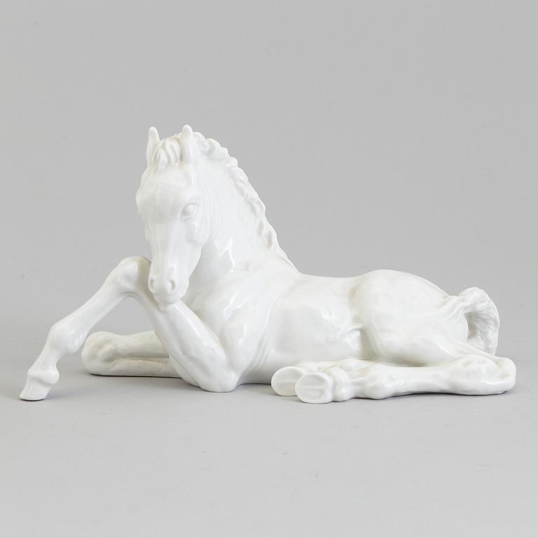 A white glazed porcelain figure of a reclining foal, Meissen, 1950's.