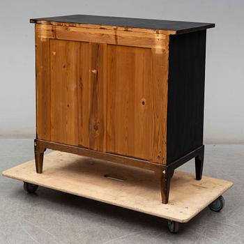 a chest of drawers from the first half of the 20th century.