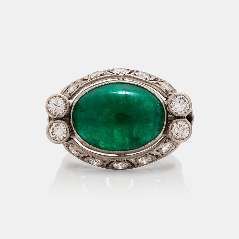 A cabochon cut emerald and brilliant cut diamond ring. Total carat weight circa 0.90 ct.