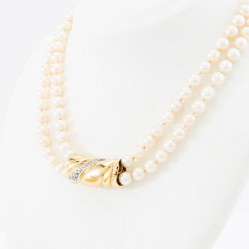 Necklace, two-stranded of cultured pearls with a clasp of 18K gold set with brilliant-cut diamonds, Damini Asolo Italy.
