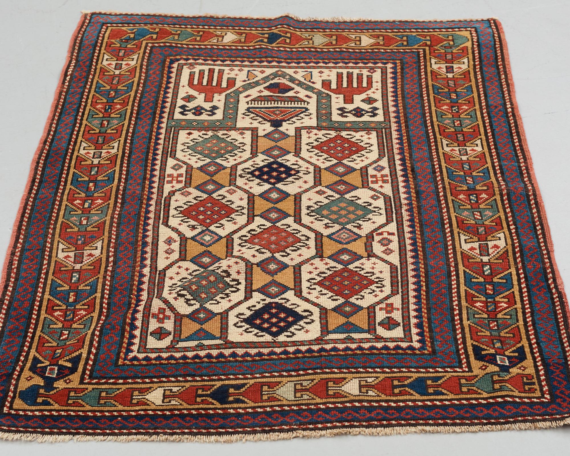A RUG, an antique Caucasian prayer rug, Czar Russia, ca 144-151 x 103-106 cm.