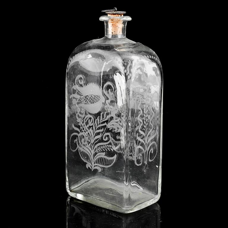 A glass bottle and three vodka glasses, 19th Century.
