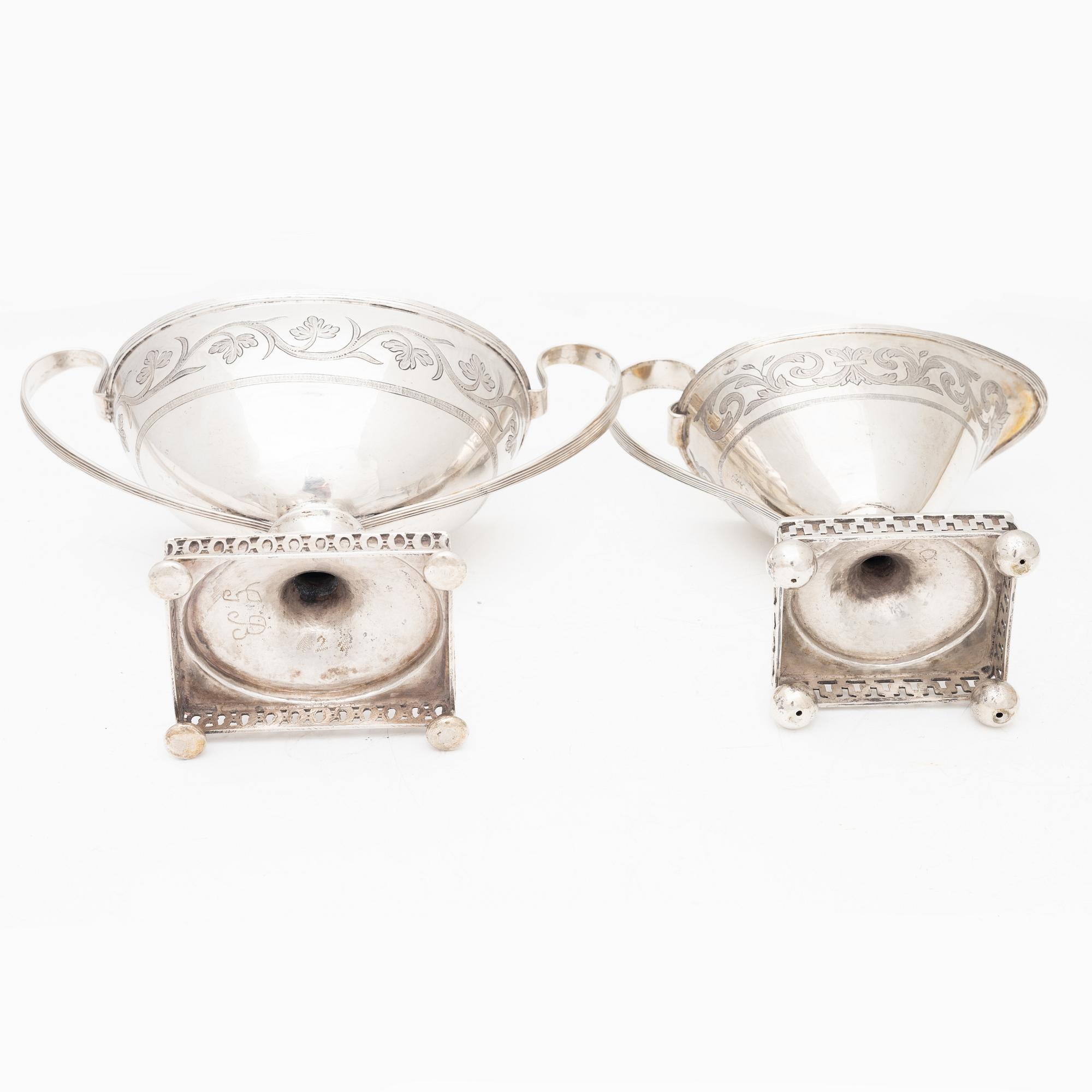 A silver sugarbowl with lid and a creamer, marks of Olof Hellbom, Stockholm, Sweden 1799-1800.