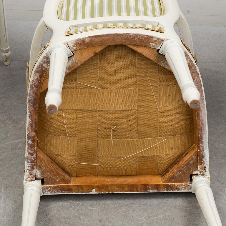 a mid 20th century dining table with four arm chairs.