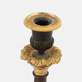 A pair of 19th century empire-style bronze candlesticks.