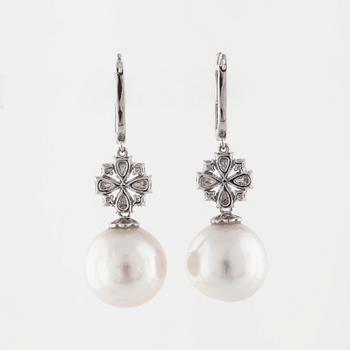 A pair of cultured pearl and brilliant cut diamond earrings.