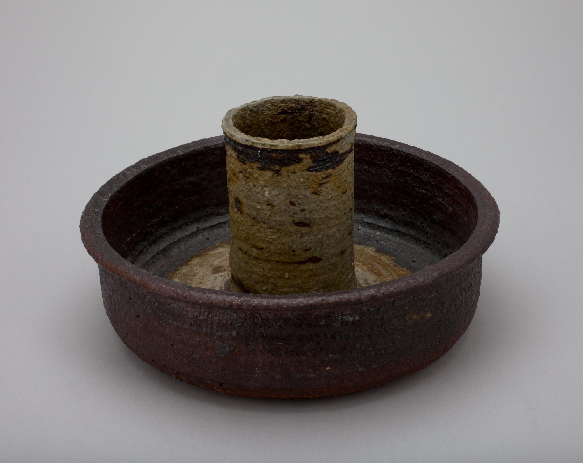 A CERAMIC CANDLESTICK.