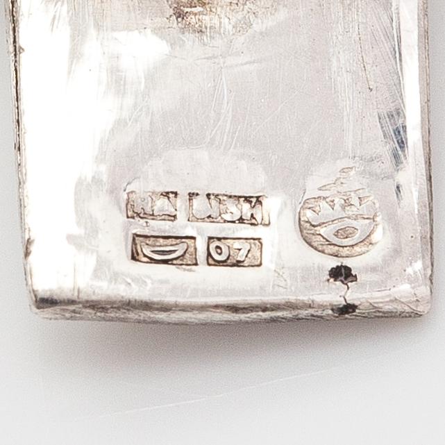 A silver bracelet and ring with turquoises. China.