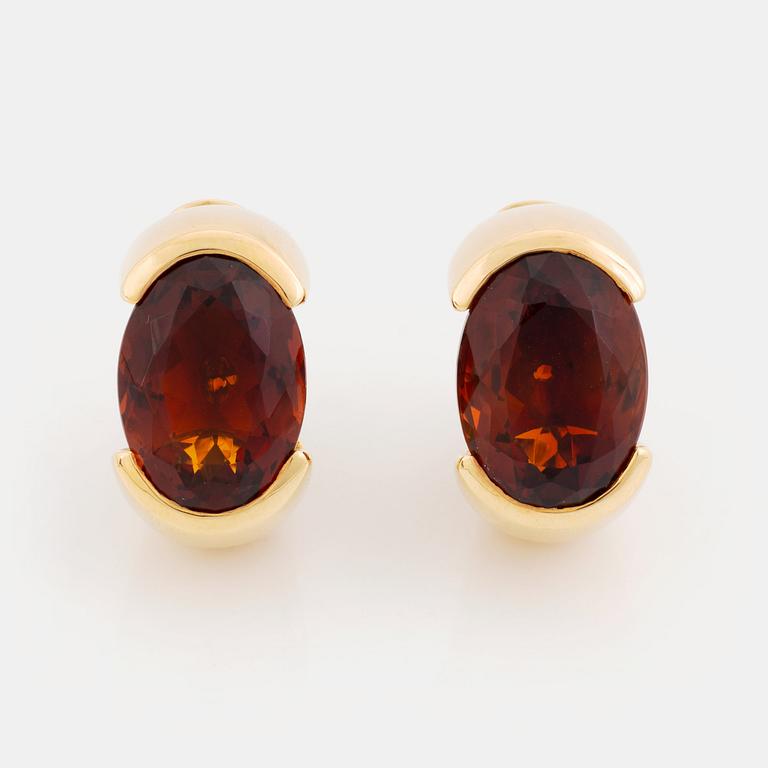 A pair of Tina Karlsson earrings in 18K gold set with faceted citrines.