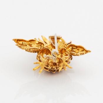 An 18K gold and enamel bird brooch set with eight-cut diamonds.