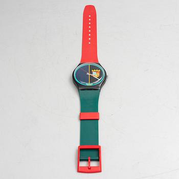A wall clock, Swatch.