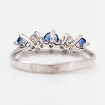An 18K white gold ring, diamonds totalling approx. 0.20 ct and sapphires.