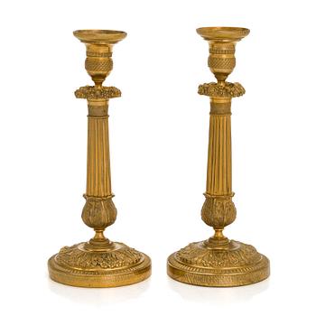 A pair of Empire ormolu brass candlesticks, France early 19th century.