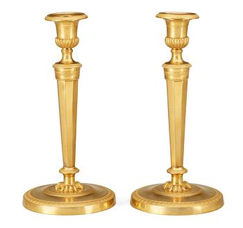 522. A pair of French Empire early 19th Century candlesticks.