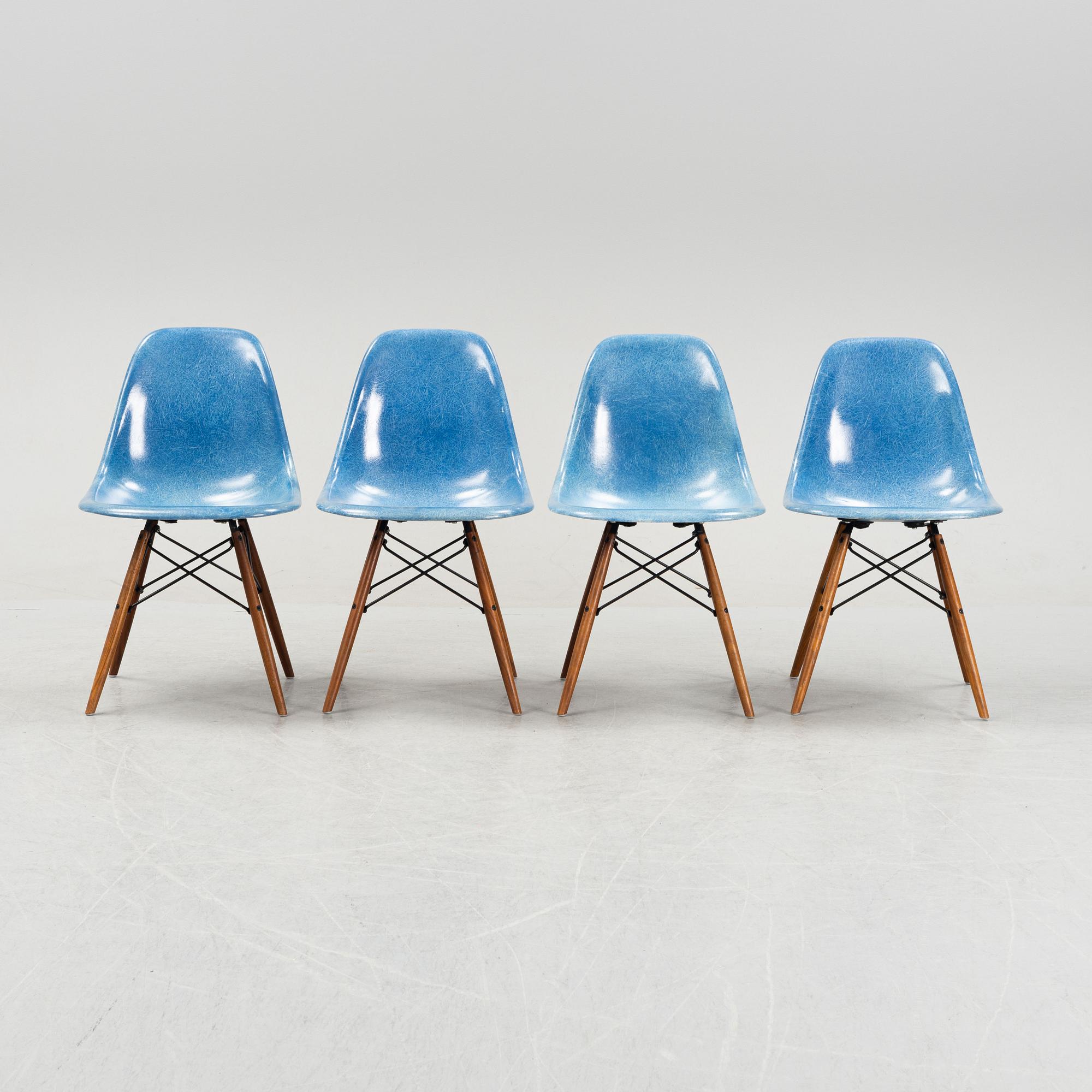 A set of four Charles and Ray Eames 'Plastic Chair DSW' with later stands, designed 1950.