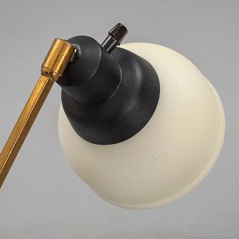 A 1950s brass and glass floor lamp.
