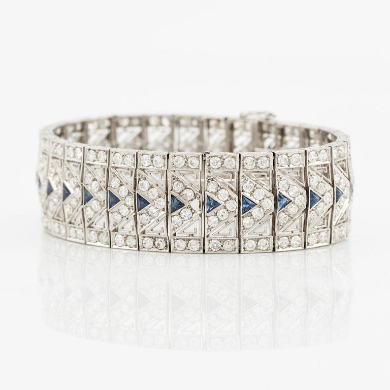 A platinum bracelet with old-cut diamonds and sapphires, likely Bucherer.