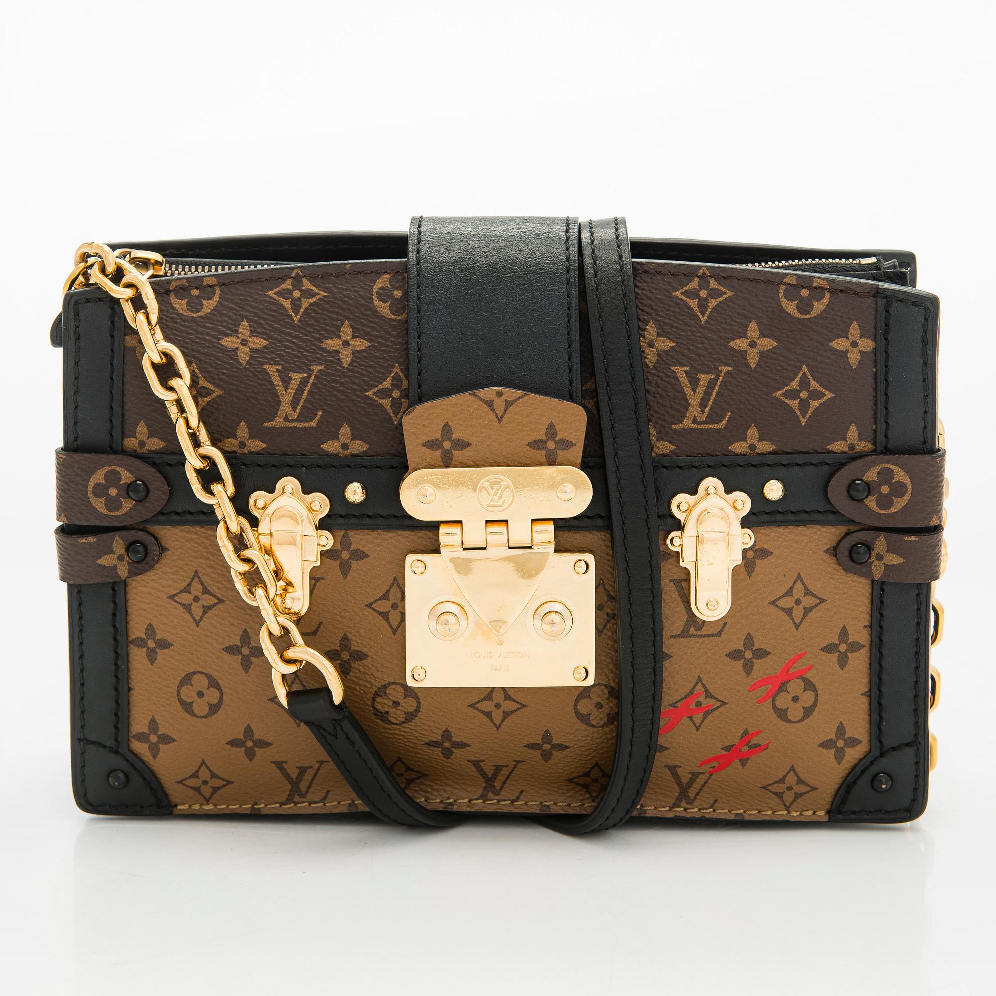 Louis Vuitton, a "Reverse Monogram Trunk Clutch" bag.