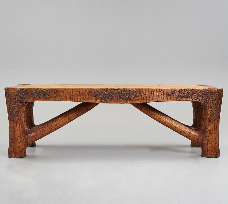 Gustaf Fjaestad, an Art Nouveau carved pine table, Arvika Sweden 1914, a double to the table in the Thiel Collection,