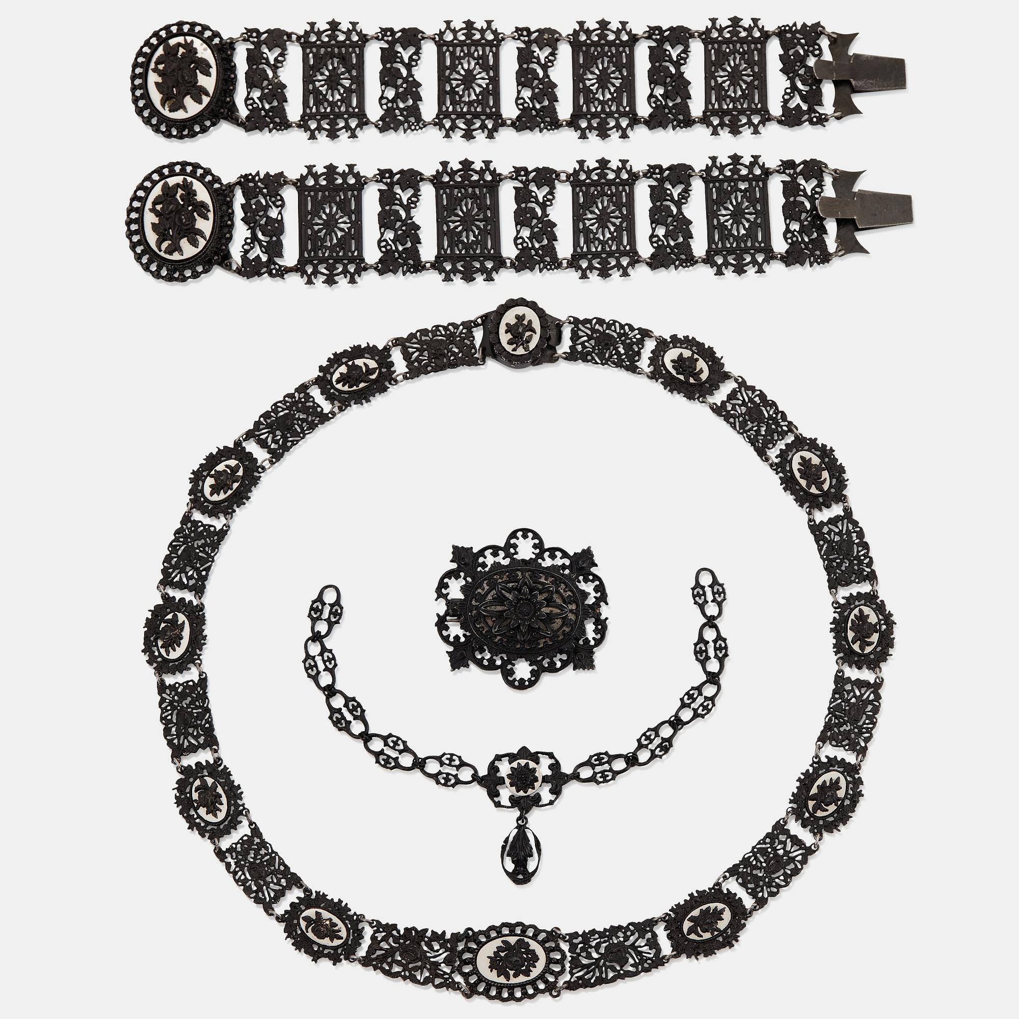 A Berlin steel and iron parure comprising a necklace, two bracelets and a brooch.
