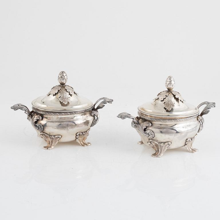 A pair of Swedish Rococo style sterling silver sauce tureens with lid and spoons, mark of Wiwen Nilsson, Lund 1947-1948.