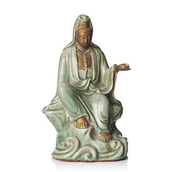 1039. A seated celadon figure of Guanyin, presumably Longquan Ming dynasty, 17th Century.